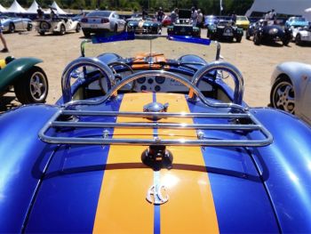 AC Cobra Luggage Rack in chrome fitted to a bright blue ac cobra with a central yellow stripe photographed close from the rear