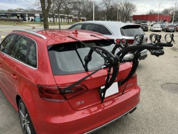 Red Audi S3 Sportback in a car park in the USA with a bike rack fitted photographed close at the rear 