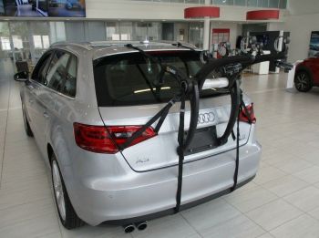 Silver Grey Audi A3 sportback with a 3 bike rack fitted photographed close at the rear in an Audi Garage