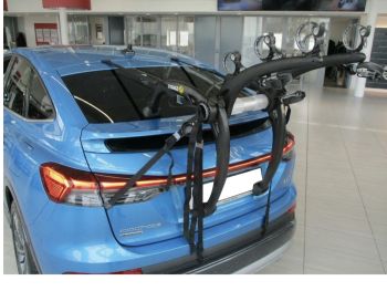 bright blue audi Q4 e tron sportback with a bike rack fitted in a showroom