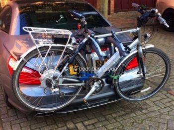 grey mercedes sl with a bike rack fitted carrying a bike outside a garage