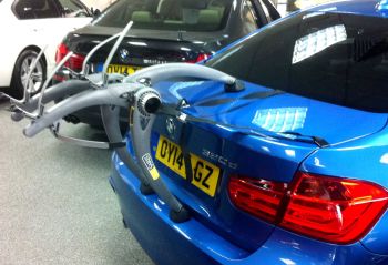 Blue BMW 5 series saloon with Bike Rack fitted in BMW showroom