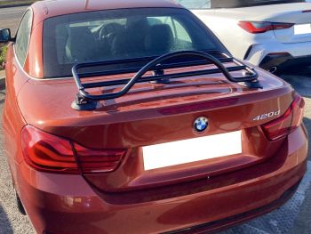Orange bmw 4 series convertible with a revo-rack luggage rack fitted photographed close from the rear