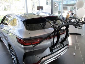 silver byd seal u in a byd showroom with a bike rack fitted to the tailgate photographed close at the rear focusing on the bike rack