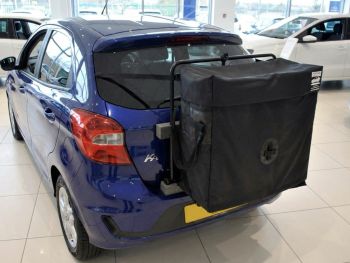 Blue Ford KA in a used car showroom with a hatchbag roof box alternative fitted photogprahed close at the rear