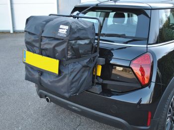 black 2024 mini F65 with a hatch-bag roof box alternative fitted to the rear photographed close 