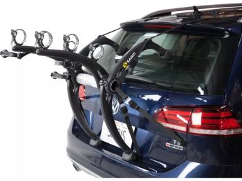 blue vw golf with a saris bike rack fitted for three bikes with no bikes fitted on a white background