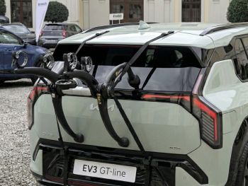 light Green Kia EV3 with a 3 bike rack fitted to the rear photographed close highlighting the bike rack