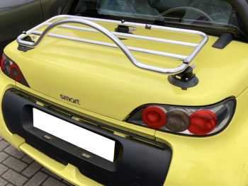 Yellow smart roadster with a revo-rack polished luggage rack attached photographed close from the rear