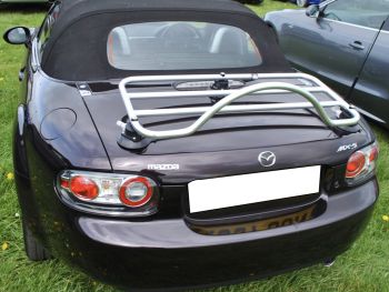 black dark burgandy mazda mx5 nc mk3 mk3.5 at a car show with a revo-rack pa chrome stainless steel luggage rack fitted to the boot photographed close at the rear
