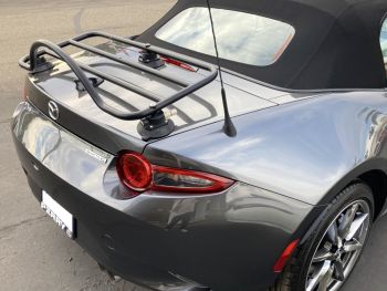 Grey Mazda Miata ND MX5 Mk4 with a Revo-Rack luggage rack fitted photographed from the rear 