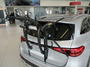 Silver Mercedes Benz GLC second generation 2020 2023 2024 2025 2026 model year with a 3 bike rack fitted to the rear photographed close in a showroom