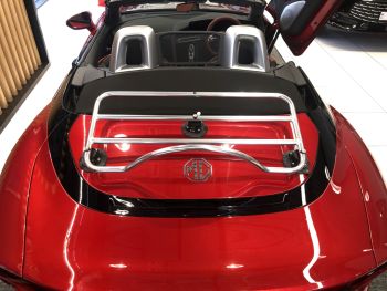 red mg cyberster with a rvo-rack pa chrome luggage rack fitted photographed close at the rear in an MG dealership