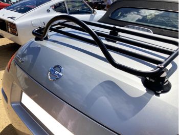 silver nissan 350z roadster with a black luggage rack fitted photographed from the rear