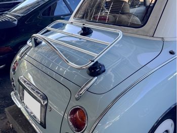 pastel blue nissan figaro with a revo-rack pa polished chrome luggage rack fitted to the rear photographed close