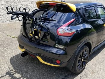 black Nissan juke with yellow spoilers and 3 bike rack fitted 