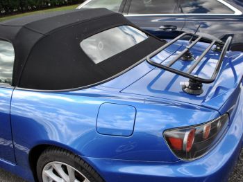 blue honda s2000 with a spoiler and a luggage rack fitted