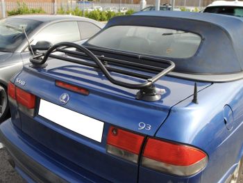 blue saab 93 cabriolet with a black luggage rack fitted in a car park on a sunny day