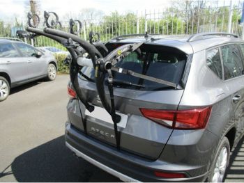 Graphite seat Ateca with a bike rack fitted to the tailgate photographed close from the rear in a car park