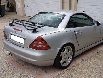 silver mercedes benz slk R170 with a revo-rack luggage rack fitted photographed opposite a garage on a driveway