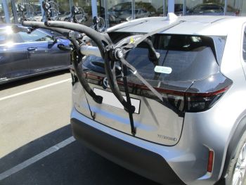 Silver Toyota Yaris Cross Hybrid Park outside a toyota garage with a bike rack fitted t the rear photogprahed close focusing on the bike rack