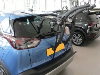 blue vauxhall crossland X in a car showroom with a Bike rack fitted photographed close at the rear