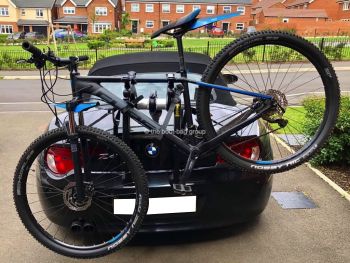 black bmw z4 e85 with a bike rack fitted carrying a mountain bike