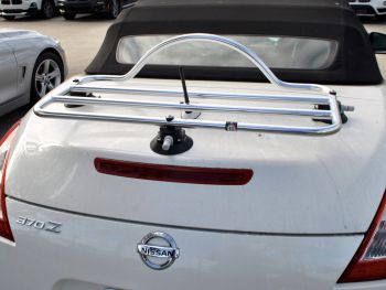 white nissan 370z convertible with a stainless steel luggage rack fitted