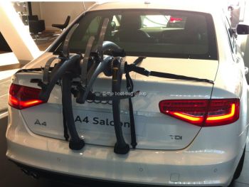 white audi a4 in a audi showroom with a two bike rack fitted