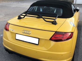 Yellow Audi TT 8S MK3 Roadster convertible with a revo-rack black luggage rack fitted to the boot lid photographed close at the rear