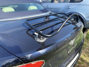 black bentley continental gt gtc convertible with a black luggage rack fitted photographed close at the rear