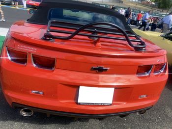 Orange chevrolet camaro model year 2016 2017 2018 2019 2020 2021 2022 2023 convertible at a car show photographed from the rear with a revo-rack luggage rack fitted 