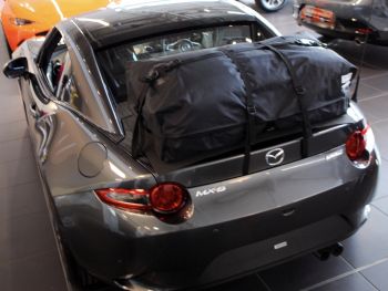 Grey miata MX5 RF with a bootbag vacation luggage rack fitted photographed from the rear