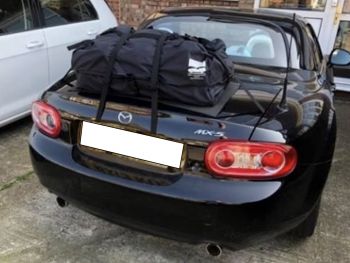black mazda mx5 miata nc mk3 prht roadster coupe photographed from the rear with a boot-bag luggage rack fitted