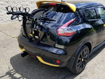 black Nissan juke with yellow spoilers and 3 bike rack fitted 