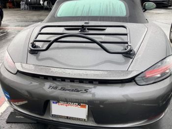 grey porsche boxster 718 S in the rain photogprahed from the rear with a revo-rack luggage rack fitted to the trunk