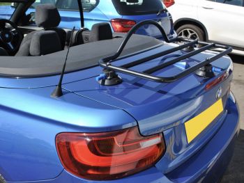 side view of a bmw 2 series convertible with a boot rack fitted hood down on a sunny day