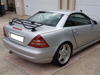 silver mercedes benz slk R170 with a revo-rack luggage rack fitted photographed opposite a garage on a driveway