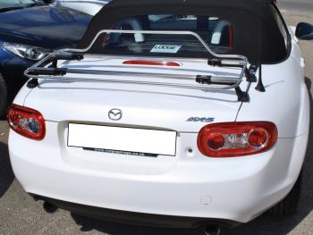 white mazda mx5 mk3 with a stainless steel luggage rack fitted photographed from the rear