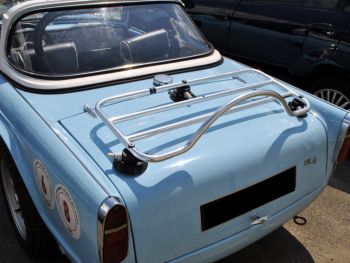 light blue triumph tr4 with a stainless steel luggage rack fitted