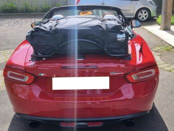 waterproof luggage bag for a convertible luggage trunk rack fitted to black luggage rack on a mazda miata nd on a sunny day